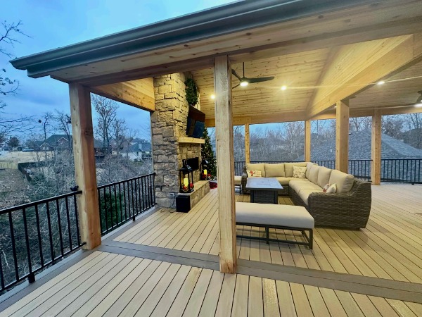 back deck with shade structure and a fireplace with a television